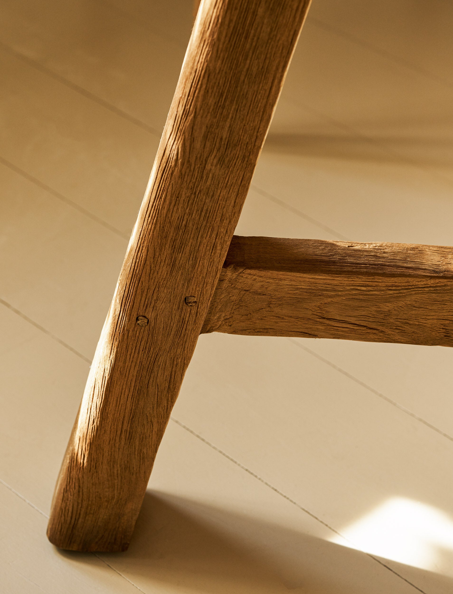Close up of leg on round wooden dining table