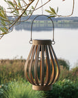Antique zinc solar LED lantern, hanging on a tree.