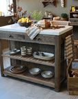 Wooden butchers block with a marble top, with ceramic dishes in a rustic kitchen setting