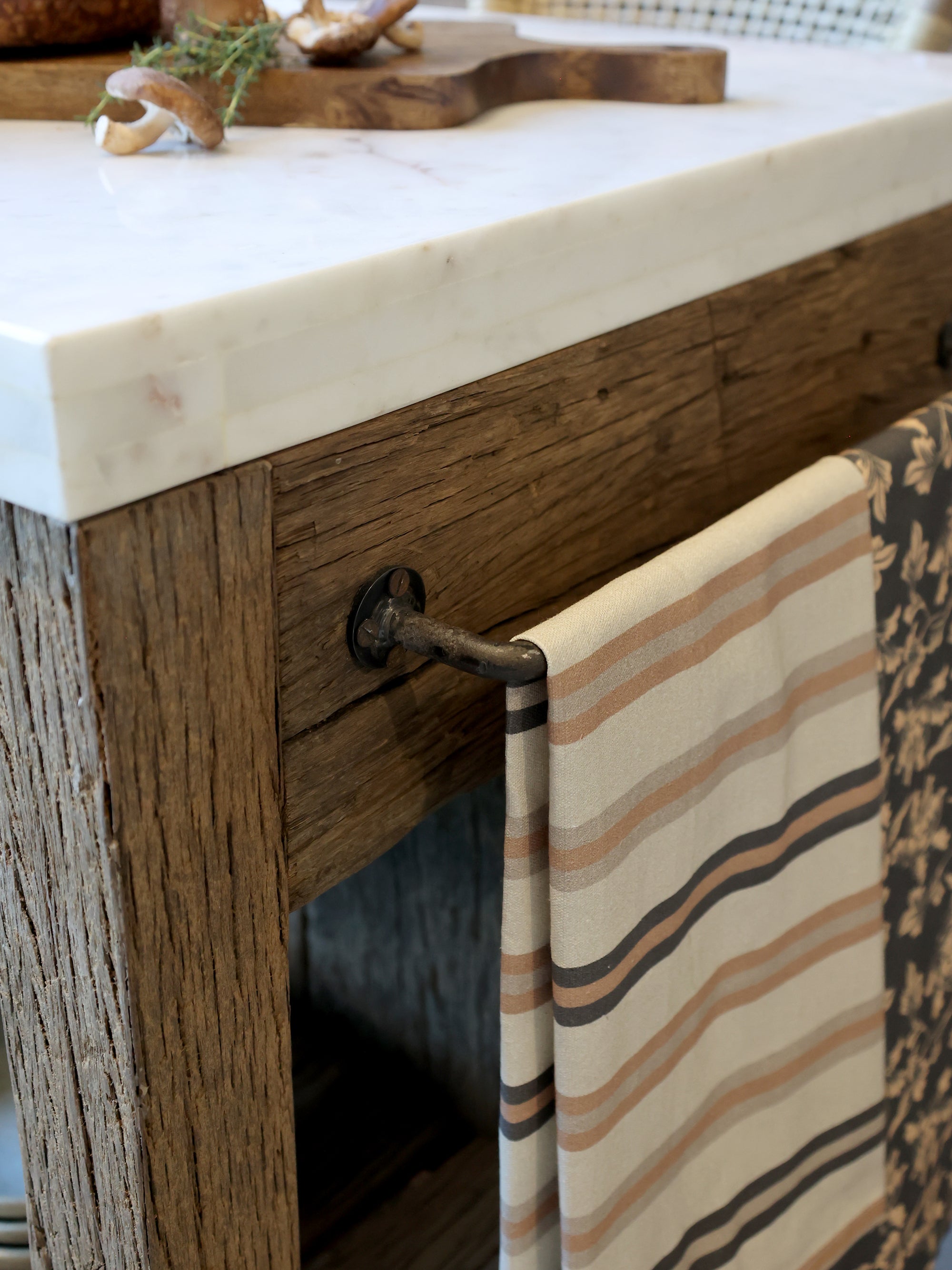 Wooden butchers block with marble top and patterned towel