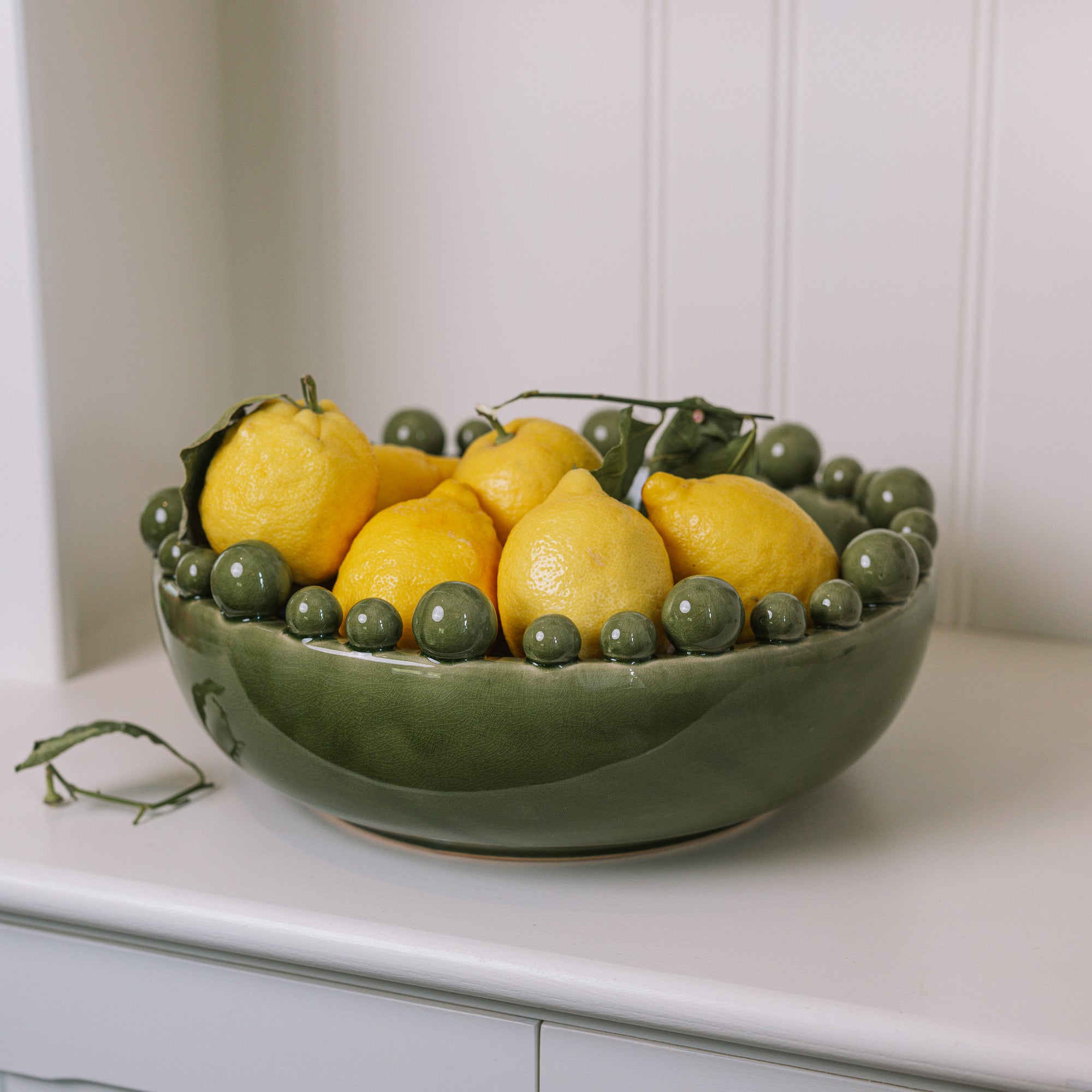ceramic green bobble bowl with lemons.