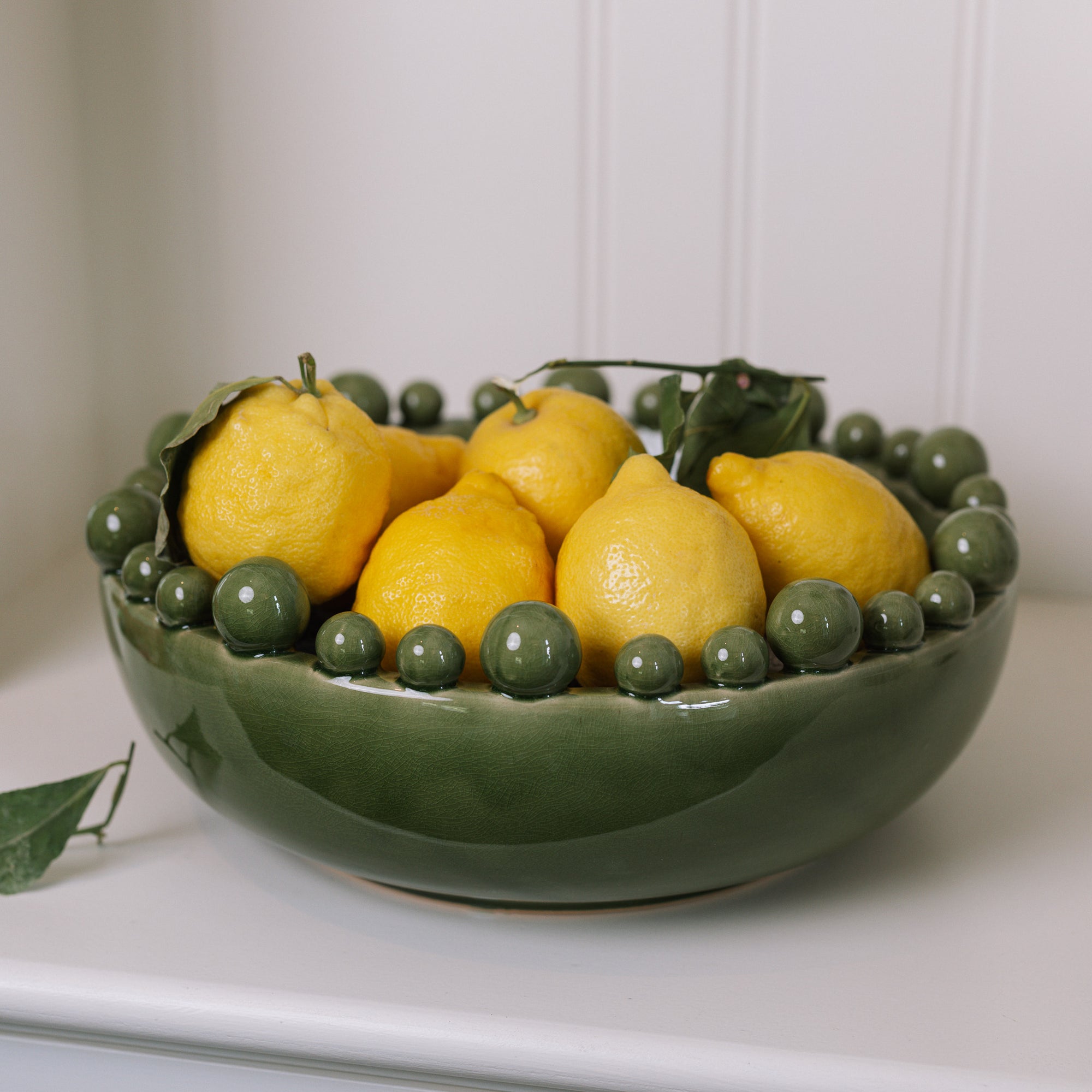 ceramic green bobble bowl with lemons.