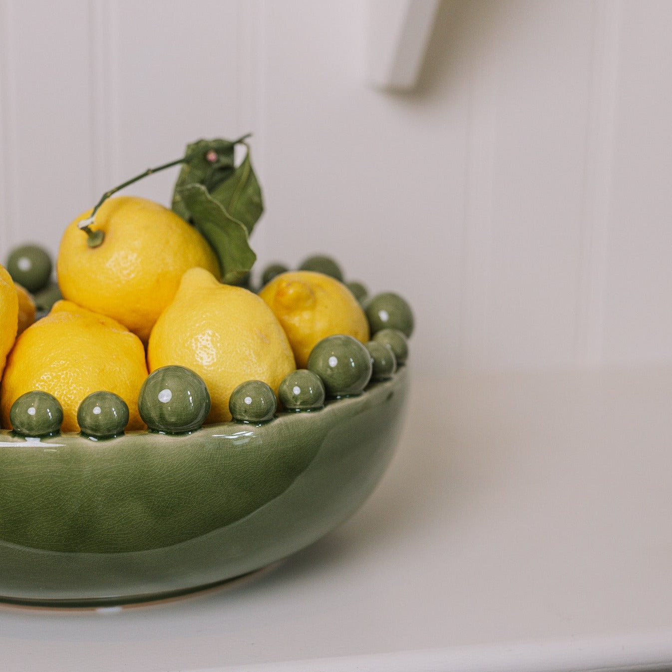 ceramic green bobble bowl with lemons.
