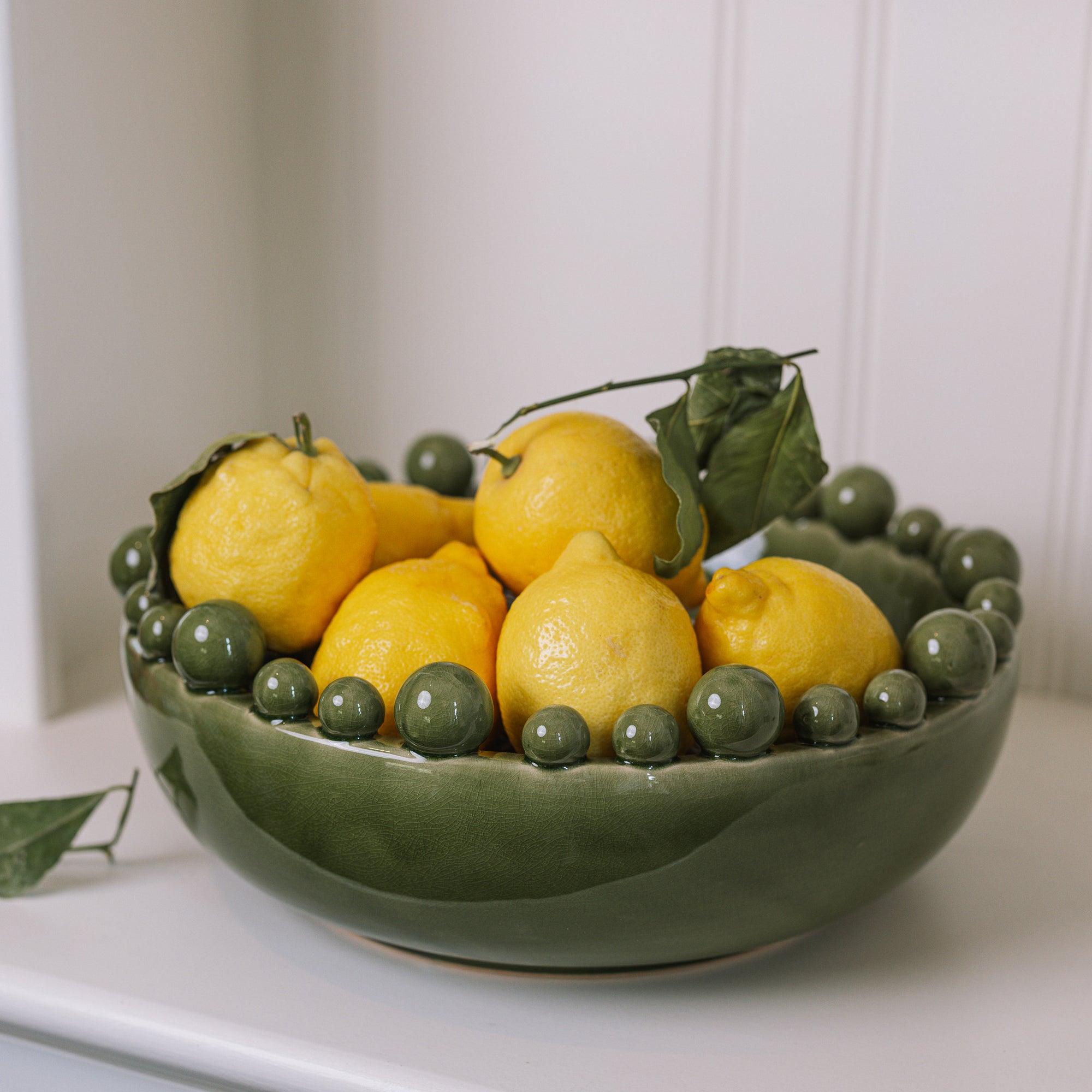 ceramic green bobble bowl with lemons.