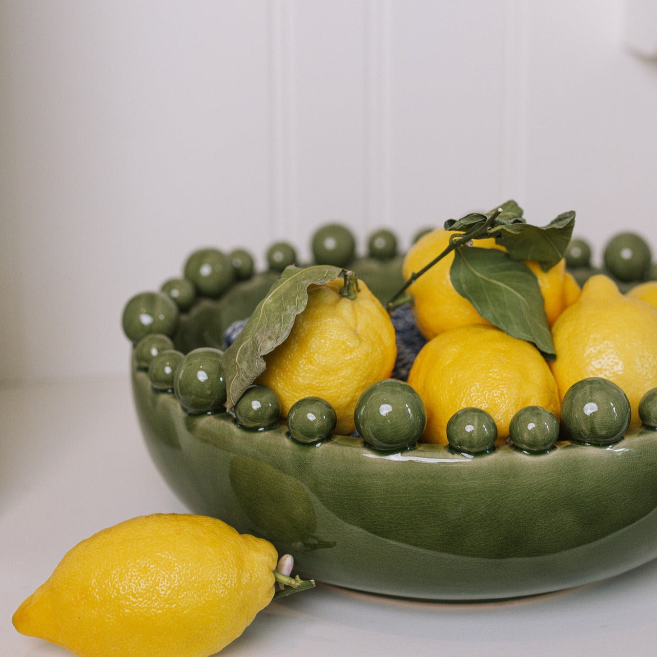 ceramic green bobble bowl with lemons.