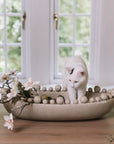 Cream oval bobble bowl with magnolia flowers and a white kitten.