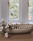 Cream oval bobble bowl with magnolia flowers.