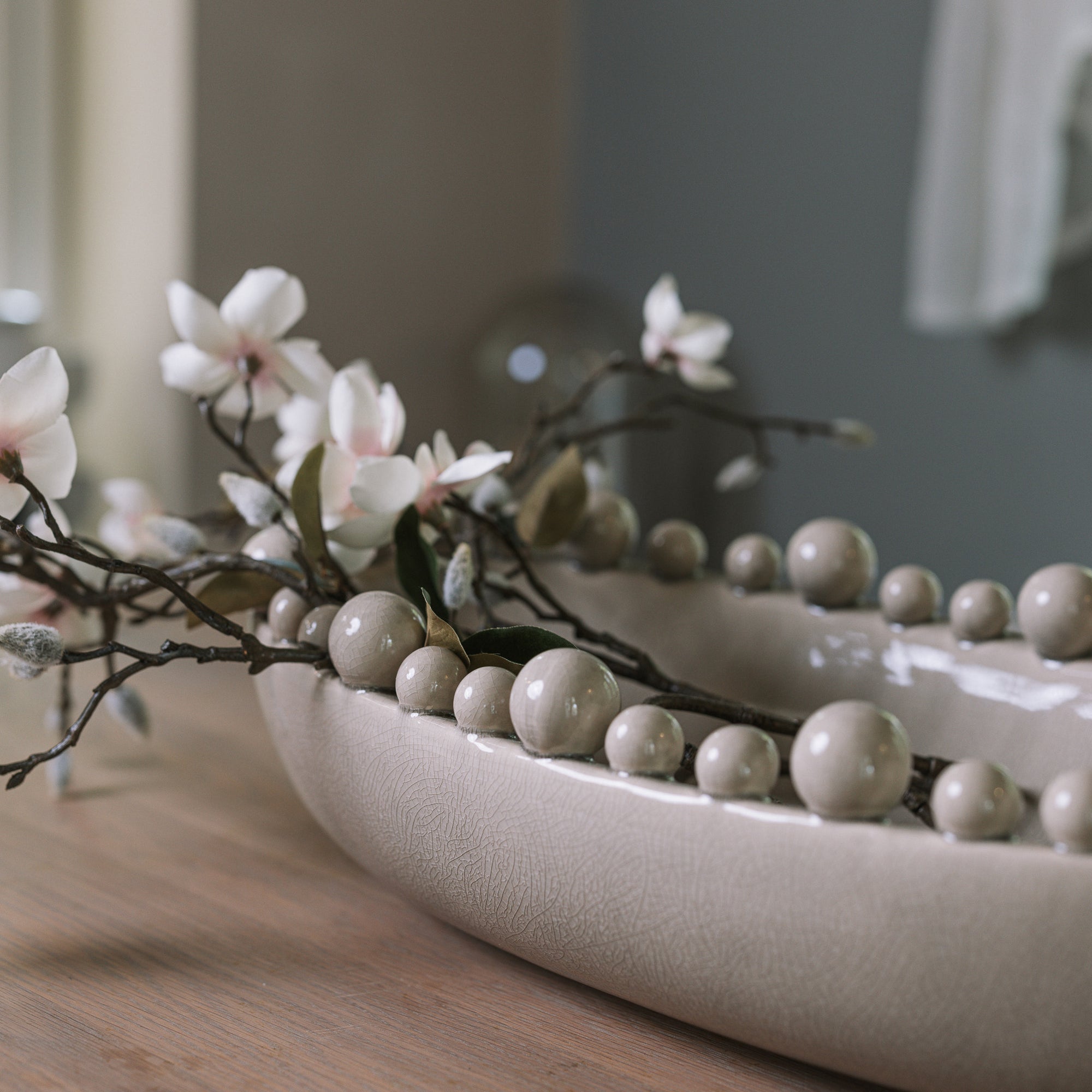 Cream oval bobble bowl with magnolia flowers.