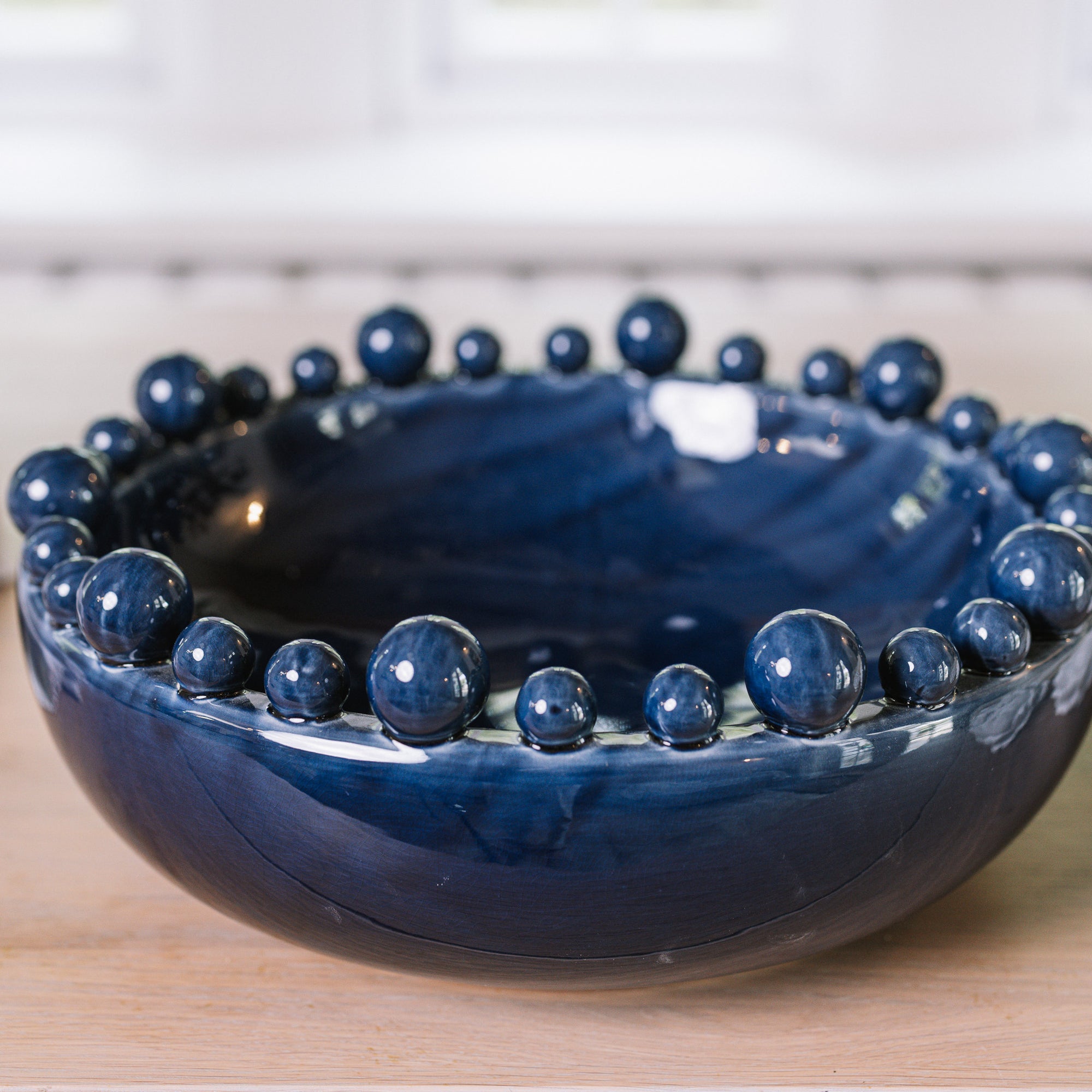 Blue ceramic bobble bowl on a wooden table.