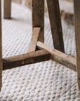 Pair of reclaimed wooden stools with book and cup of tea.