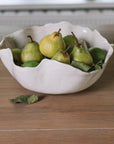 Wavy Ceramic Bowl filled with pears and leaves.