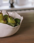 Wavy Ceramic Bowl filled with pears and leaves.