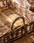 Close-up of a natural woven trays with a decorative handle.