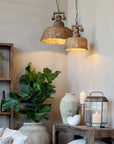 Two rattan pendant lights hung up and switched on.