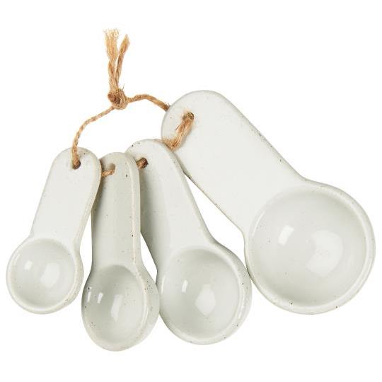 White porcelain measuring spoons tied together with rope.