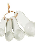 White porcelain measuring spoons tied together with rope.