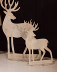 2 white reindeer decorations.
