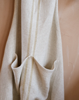 Close up of detailing on cream striped linen apron.