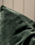 Close up of square velvet cotton green cushion.