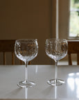 Set of four textured red wine glasses