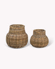 Two rattan storage baskets on a white background