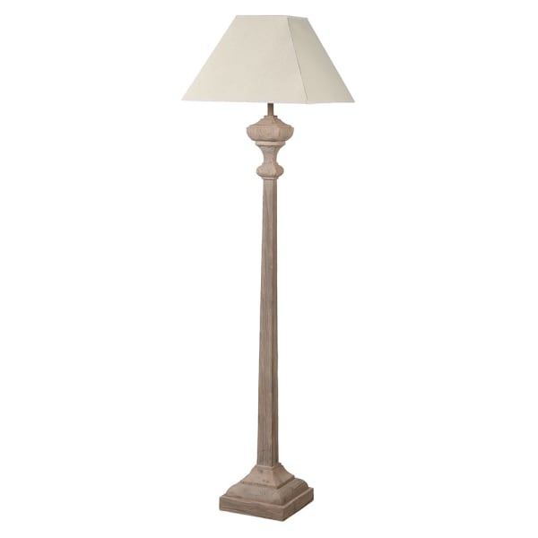 Carved wooden floor lamp with white linen shade.