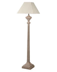 Carved wooden floor lamp with white linen shade.