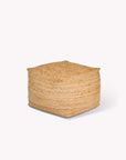 Woven cube-shaped jute pouf on a white background
