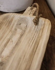 Close up of wooden tray handle with rope.