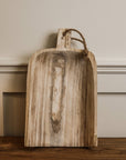 Small wooden tray balanced up against a wall.