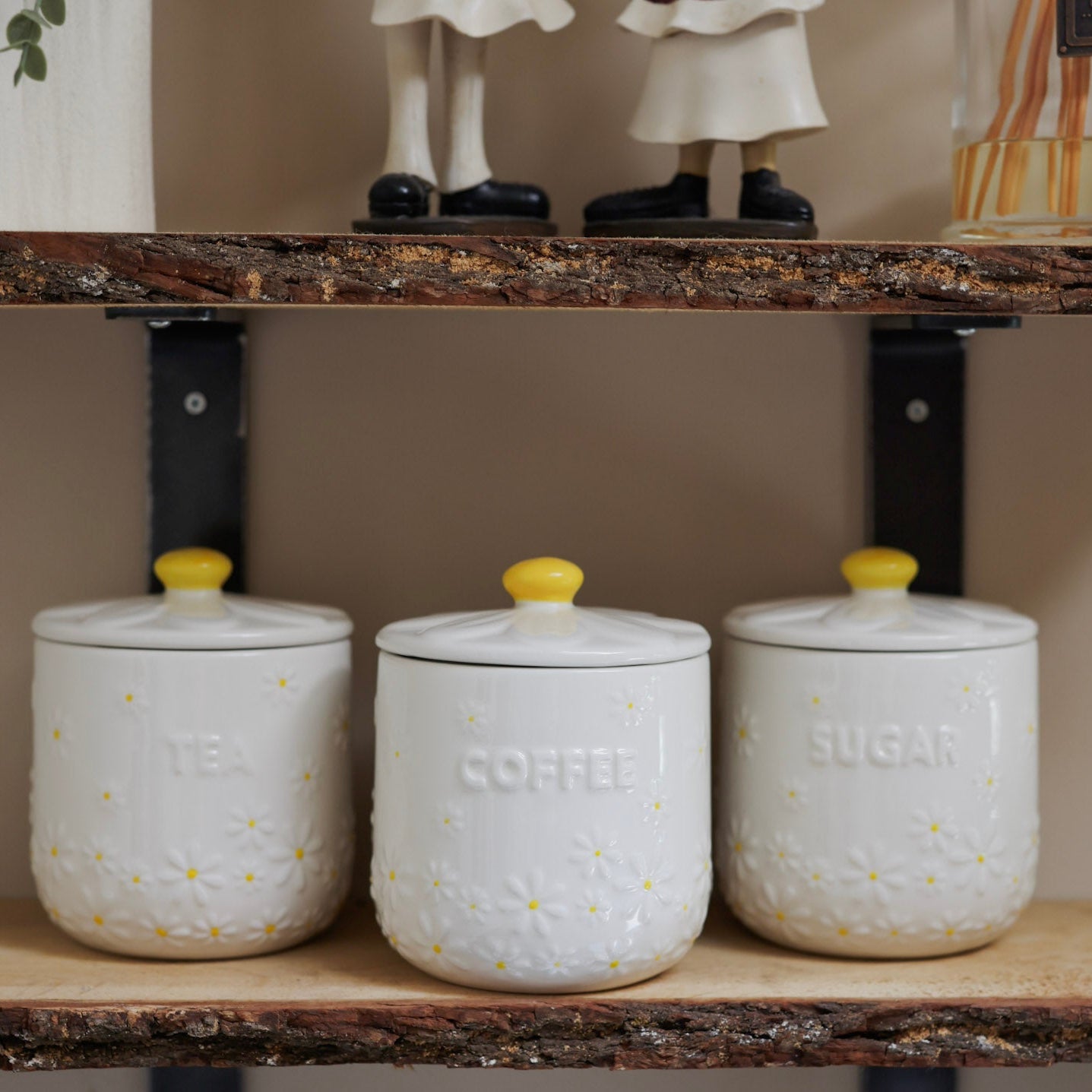 Daisy Tea coffee sugar canisters on wooden shelf