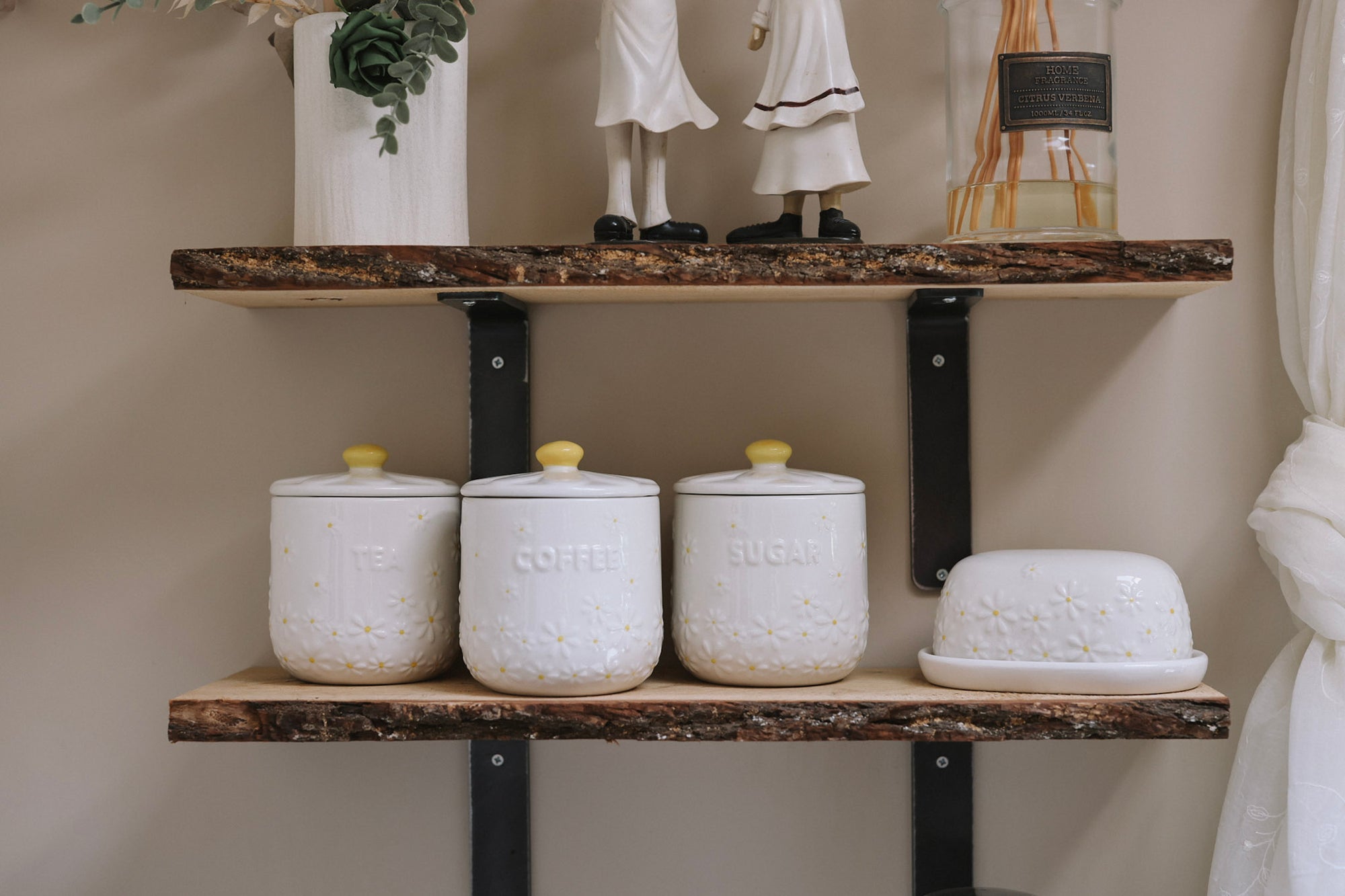 Daisy Tea coffee sugar canisters on wooden shelf with butter dish