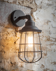 Dalton Black Outdoor Wall Light on exposed stone wall.