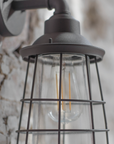 Dalton Black Outdoor Wall Light on exposed stone wall