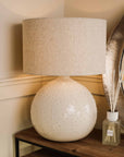 White textured ceramic table lamp with a clear diffuser.