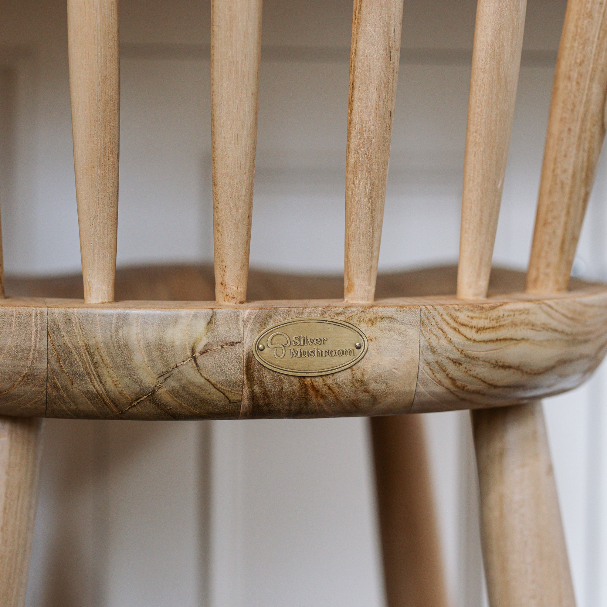 Silver Mushroom brass badge on a Farmhouse Bar Stools With Back.