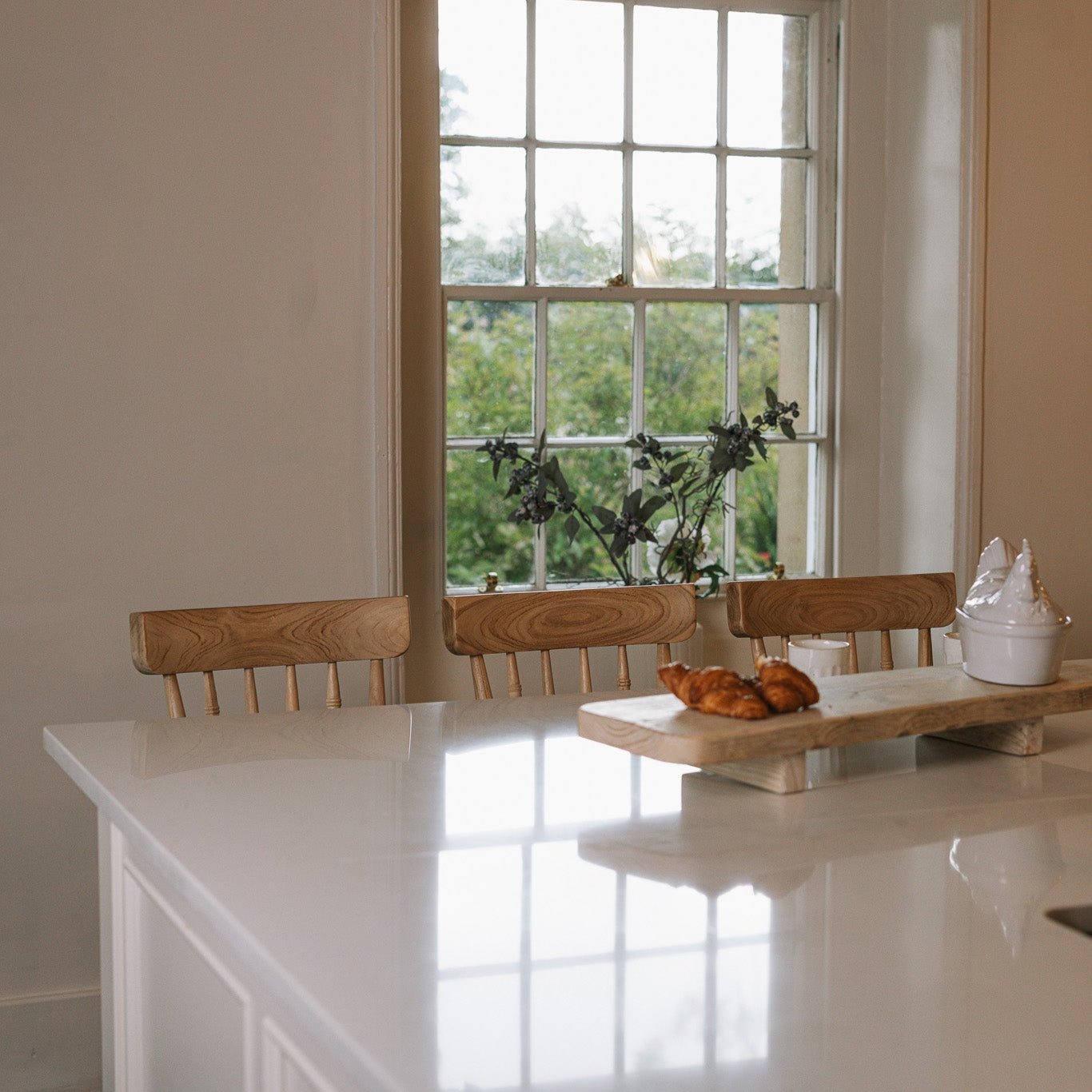 Three Farmhouse Bar Stools With Backs in a bright and characterful kitchen.