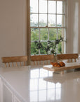 Three Farmhouse Bar Stools With Backs in a bright and characterful kitchen.