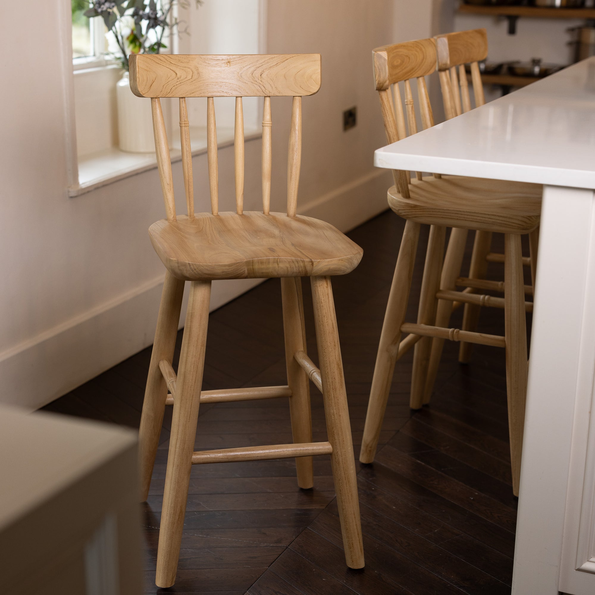 Three Farmhouse Bar Stools With Backs in dark wood kitchen.