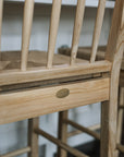 Farmhouse Rattan Bar Stool in kitchen with dark wood floor with badge.