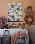 French style wooden dining chair at a table with autumnal decorations and an orange throw.