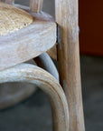 Close up of white washed patina finish on wooden dining chair.