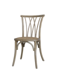 Wooden dining chair with cross back, wicker seat and white washed finish.