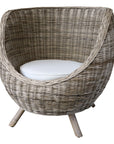 Rattan outdoor armchair with white cushion