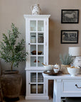 White display cabinet with glass doors open and kitchen accessories on the shelves.