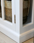Close up of corner and hinges on white display cabinet.