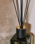detail shot on Green florist Sences reed diffuser by stone wall.