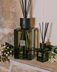 Green florist Sences reed diffuser in XL and mini on stone windowsill.