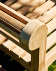 Close-up of a wooden bench with a blurred background
