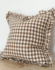 Brown gingham linen cushion with ruffled edge.